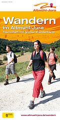 Tourenheft mit großer Wanderkarte. Zudem sind auf der Wanderkarte drei Wanderer mit Rucksäcken zu sehen.